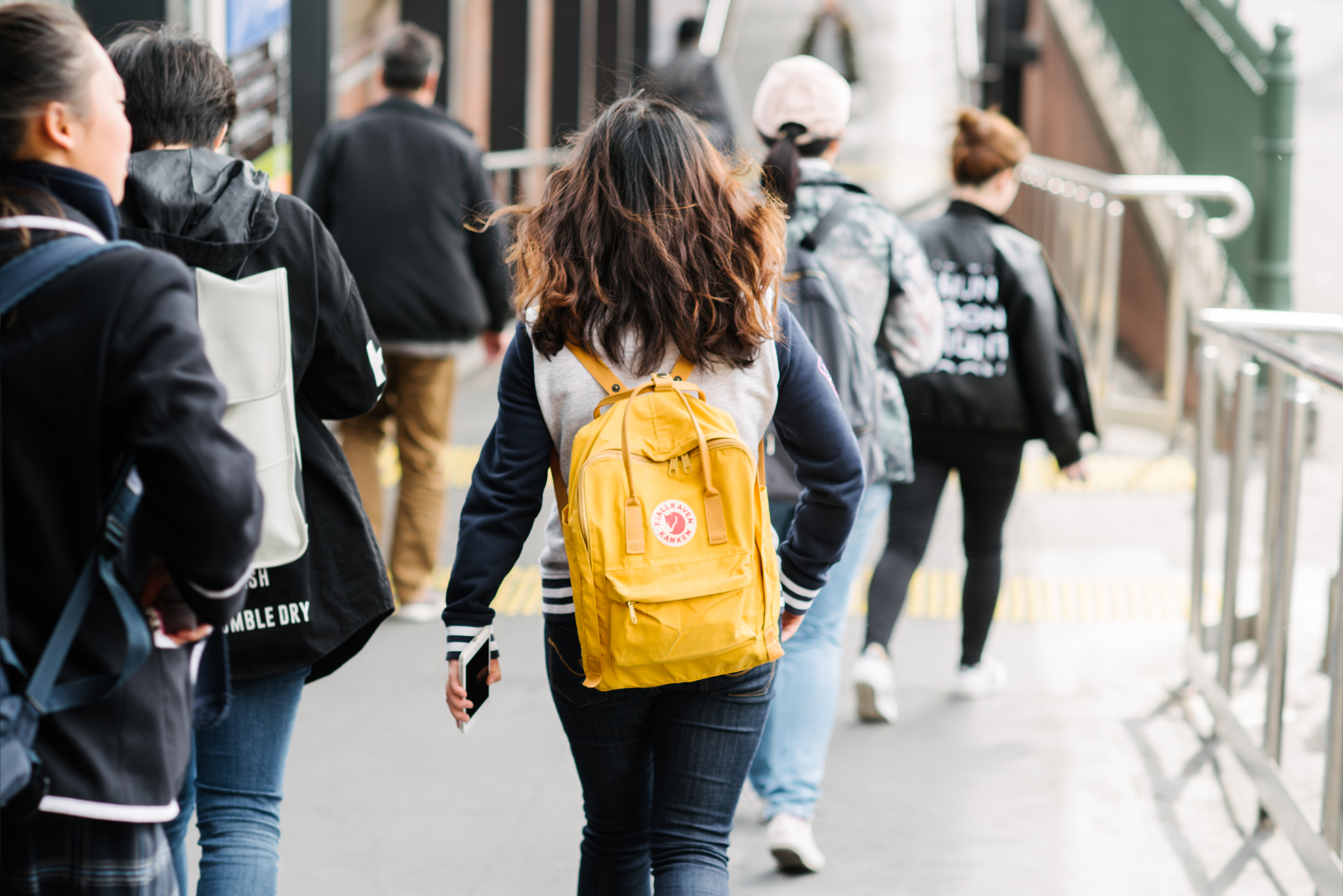 Photo of a student walking with a backpack